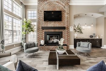 A living room with a fireplace and a television above it